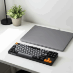 A stylish photo of the NuPhy Air75 V2 keyboard on a modern, clean desk next to a laptop. The image showcases the keyboard's unique design and aesthetic appeal for creative professionals.